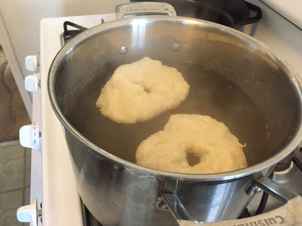 Wrinkly bagel dough from overworking during shaping.