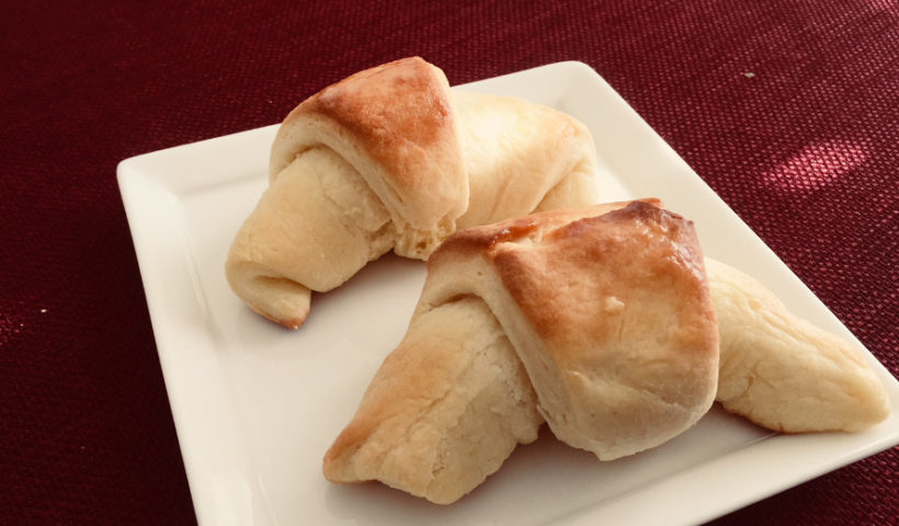 Two crescent rolls (butterhorns) in a white dish on a maroon tablecloth crescent rolls recipe baking Those Someday Goals