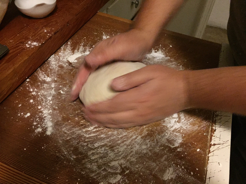 Andy shaping pita dough on a floured cutting board Homemade Pita Bread Recipe Those Someday Goals