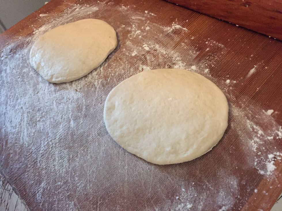 Rolled pita dough on a floured cutting board Homemade Pita Bread Recipe Those Someday Goals