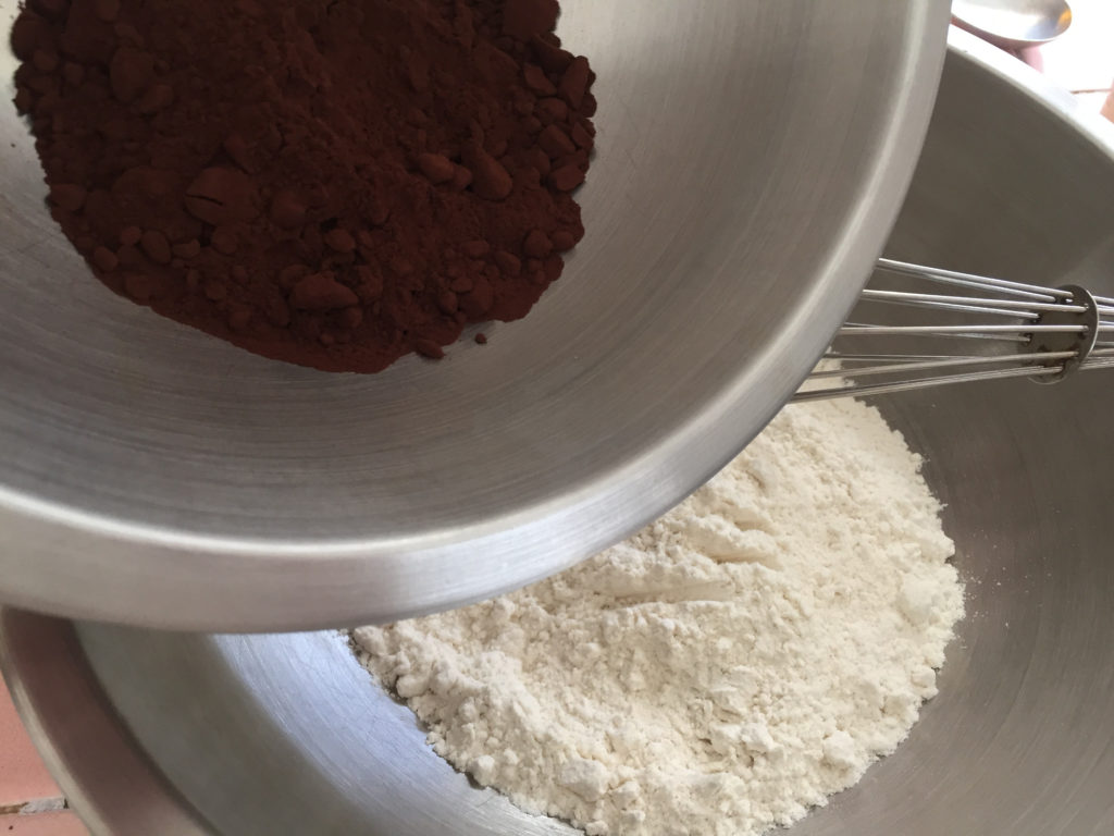 Adding cocoa powder to flour and whisking Chocolate Pound Cake Recipe Loaf Those Someday Goals