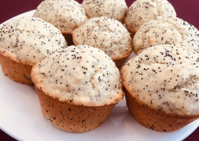 Cooling finished muffins on a white plate Lemon Poppy Seed Muffins baking Those Someday Goals