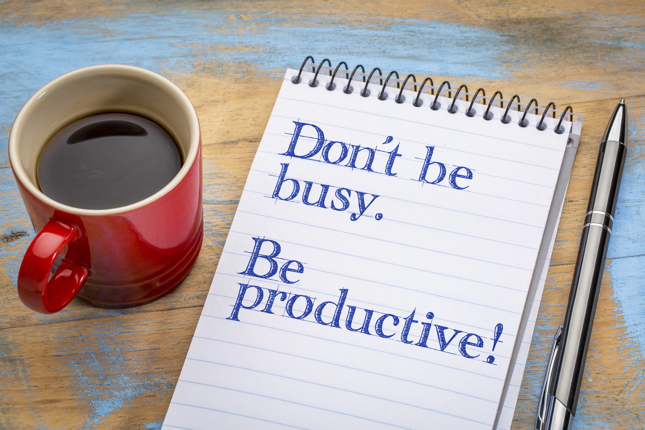 Don't Be Busy. Be Productive! Notepad, pen, coffee cup. Productivity Tips Shutterstock Those Someday Goals