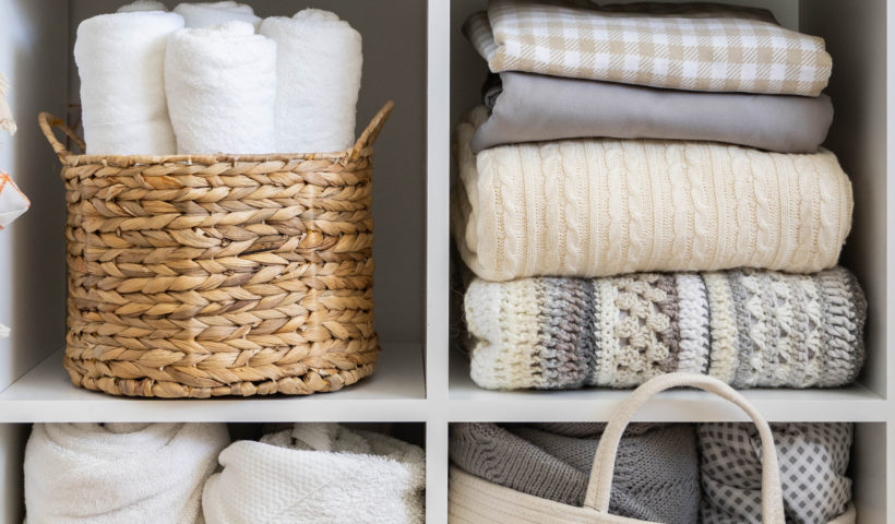 Linen closet bins and items in neutral colors from shutterstock decluttering the linen closet Those Someday Goals