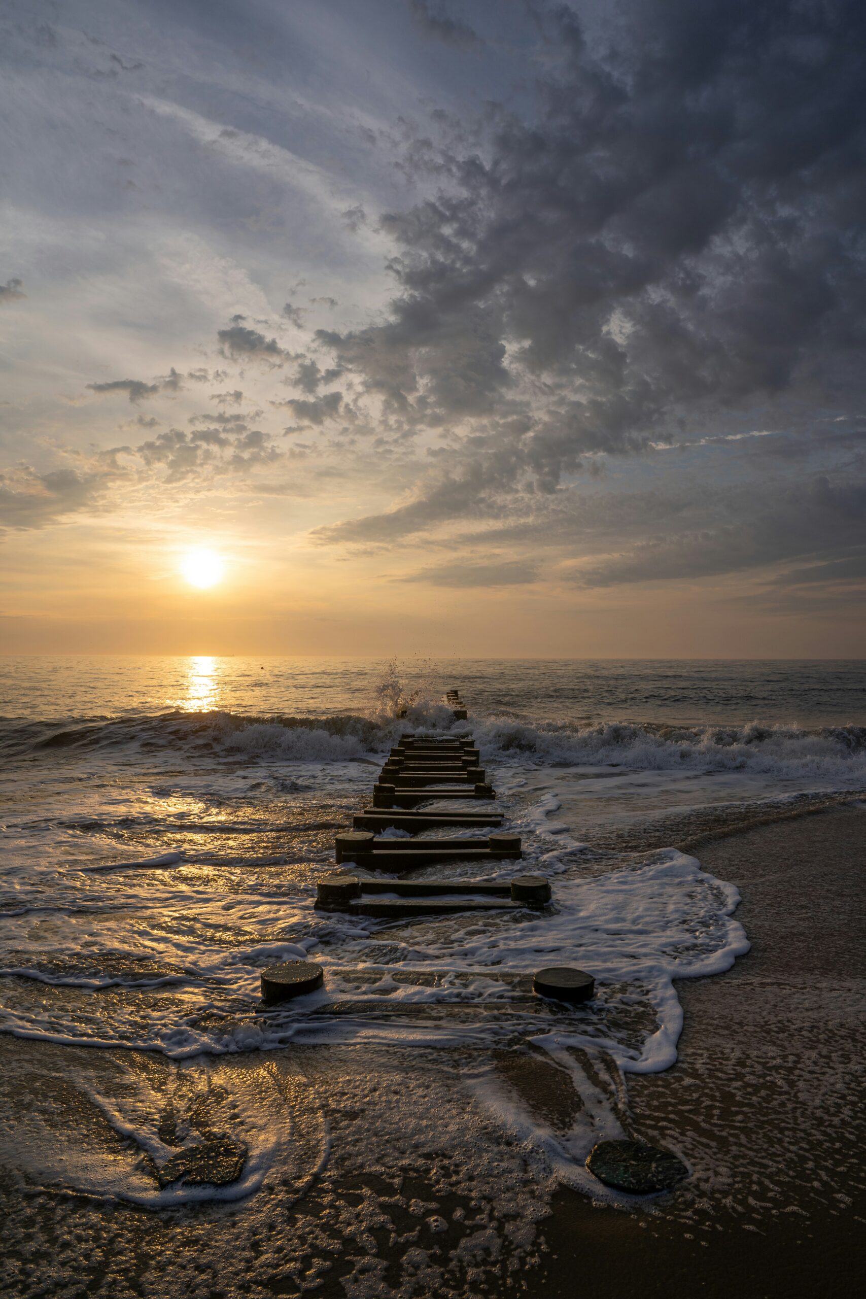 Finding your Resilience Sunrise over beach and water covered jetty bryce-wendler-3Uq1j0VGvqs-unsplash