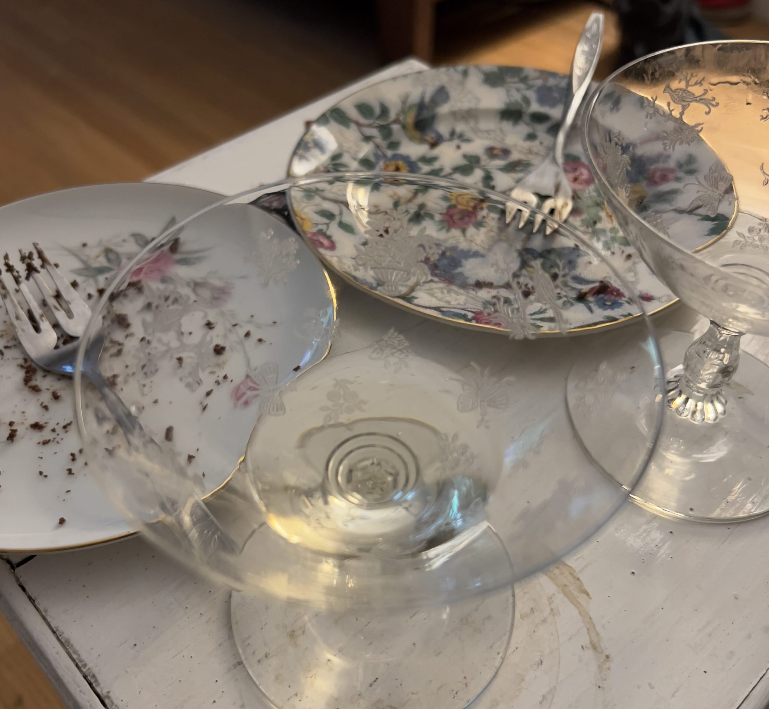 New Year’s resolutions Empty Champagne glasses china cake plates with chocolate flourless cake crumbs 2025