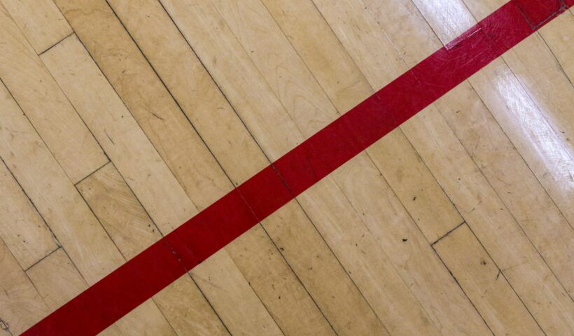 Wood floor with a red stripe by Mick Haupt UnSplash Floor Decluttering Method Decluttering tips