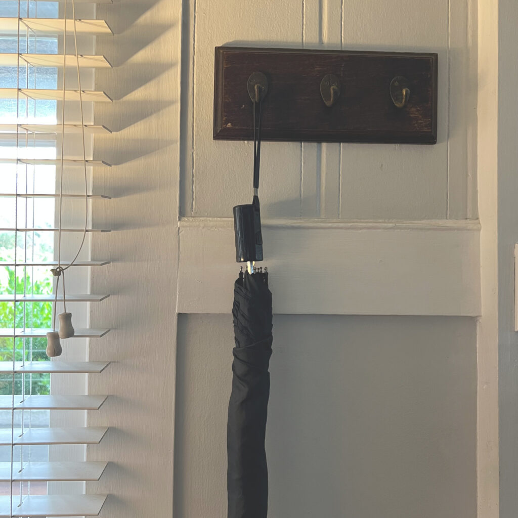 Door hooks for winter clothing. Brown metal hooks against a gray and white wall and white blinds Cozy closet refresh jacket hooks Those Someday Goals