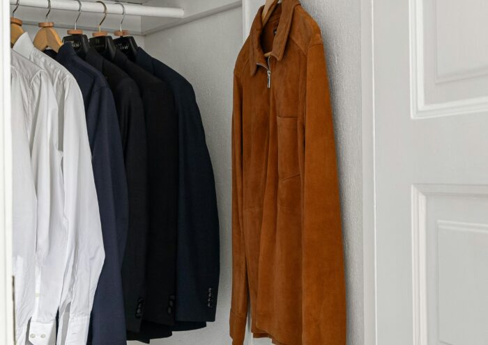 Small white closet with a jacket and button-down shirts Cozy Closet Refresh Those Someday Goals