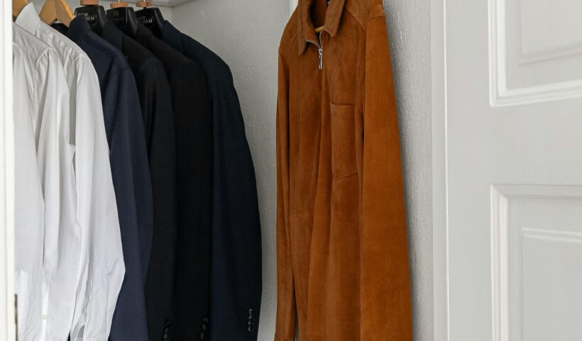 Small white closet with a jacket and button-down shirts Cozy Closet Refresh Those Someday Goals
