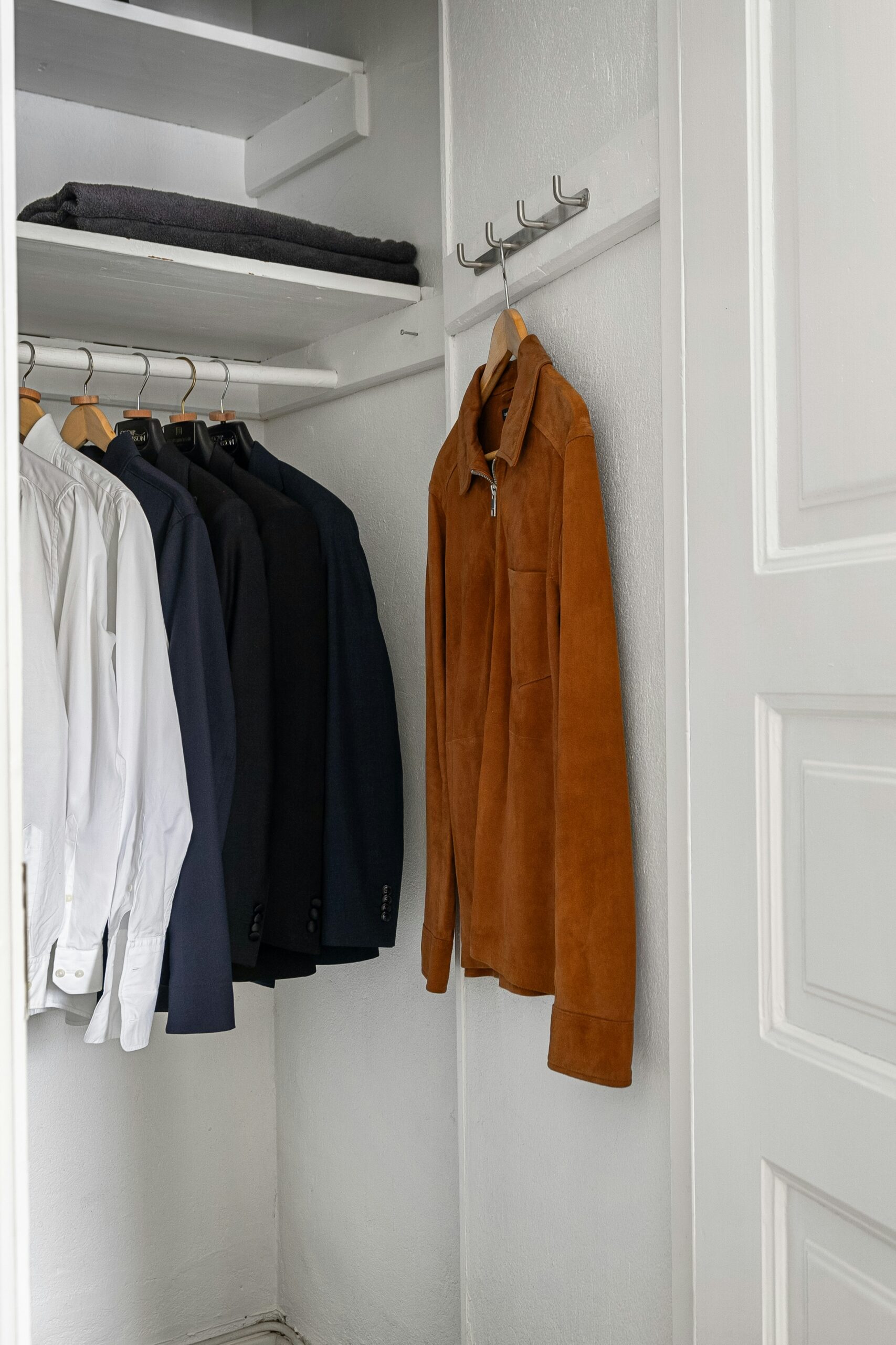 Small white closet with a jacket and button-down shirts Cozy Closet Refresh Those Someday Goals